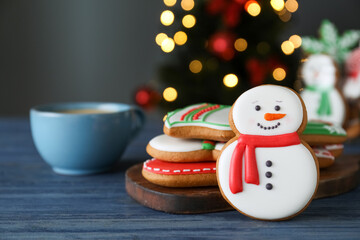 Decorated Christmas cookies on blue wooden table