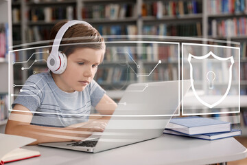 Child safety online. Little boy using laptop indoors. Illustration of internet blocking app on...
