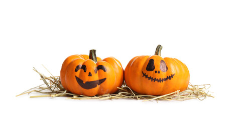 Cute Halloween pumpkins and straw on white background