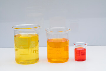 Beaker with color liquid. Solution chemistry. Laboratory beaker with colored liquid over white...