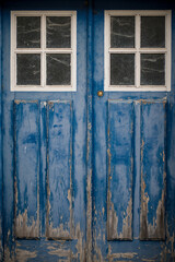 Close up of old, blue, wooden door with windows