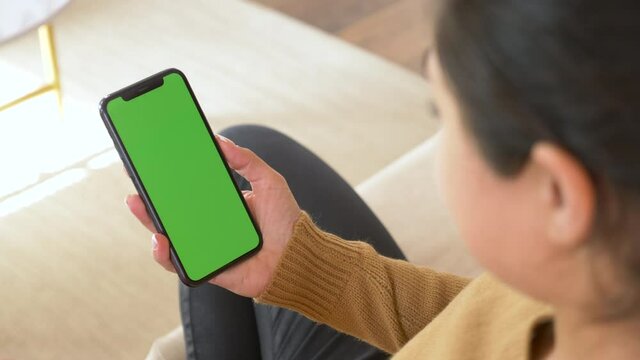 Smartphone in Indian woman hand, static footage with little hand moves. indicators on screen to track movement. Indian Young Woman Talking on Video call Online in A bright Cozy Room