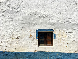 Little window in the white wall. Traditional Portuguese house from Alentejo region