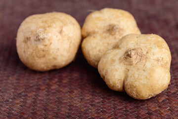 Fresh jicama or yam on bamboo sheet. Jicama can be eaten raw or cooked, The taste are crisp, juicy, moist, and slightly sweet