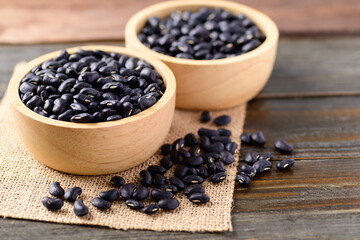 Black kidney beans in a bowl on wooden background