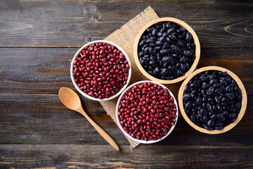 Black kidney beans and azuki beans in a bowl on wooden background, Top view