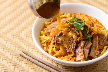 Northern Thai food (Khao Soi), Spicy curry noodles soup with beef in a bowl