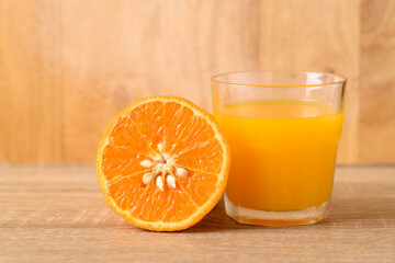 Fresh Honey Murcott orange fruit and juice on wooden background