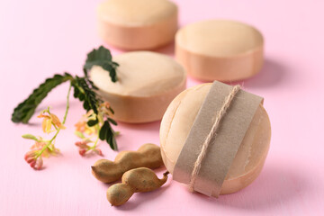 Tamarind soap on pink background, organic natural product for skin care