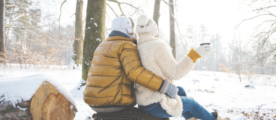 happy loving couple in snowy winter forest