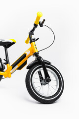 yellow balance bike on white background, close-up view