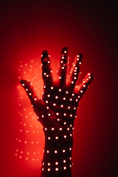Human Hand Covered With Red Led Lights, Illuminated Background