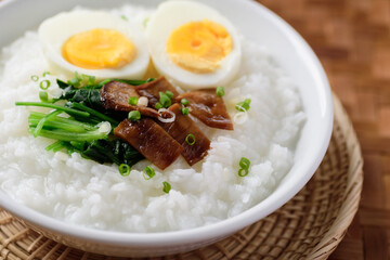 Asian food, Rice soup with boiled egg, grilled mushroom and spinach in bowl