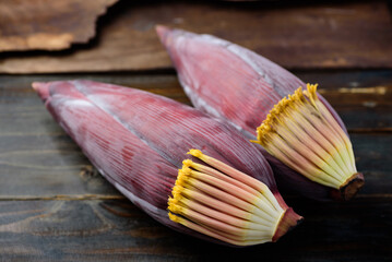 Banana flowers on wooden background, Edible plant in Southeast Asian cuisine, food ingredients in salad, curry or soup