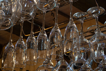 Wine glasses hang upside down