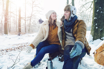 happy loving couple in snowy winter forest
