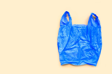 Colorful plastic bags on yellow background.