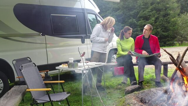 Friends in Their 40s Looking In Local Map For Best Trails For Tomorrow Hike