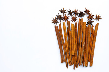 Star anis and cinnamon sticks on white background.