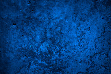 Dark blue grunge stone background. Toned concrete cement texture background. Rough concrete wall surface. Navy blue grunge banner.