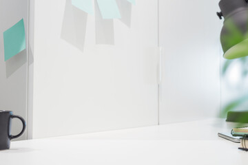Clear table in the office for mockup or product montage. Bright minimal, blurred and stylish workspace.