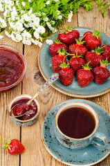 Ripe red sweet strawberry jam, fresh berries on wooden table