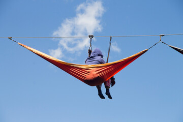 group of people relaxed in extreme hammocks high up in the mountains