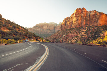 Fototapeta na wymiar Curved red rock asphalt road running through Zion National Park, Utah