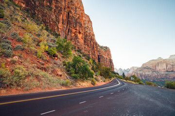 Scenic curved red rock asphalt road in Zion National Park, Utah