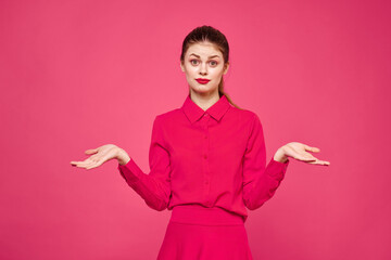 Woman on a pink background in fashionable clothes and bright makeup hairstyle model Copy Space