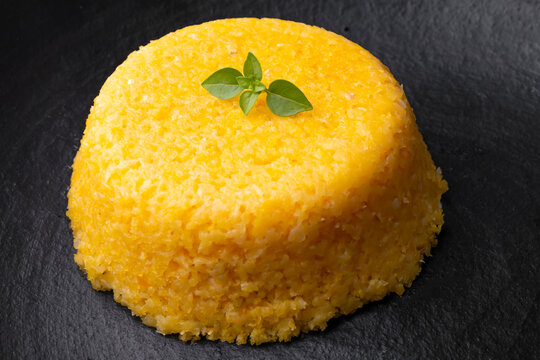 Brazilian Northeast Couscous (Cuscuz Nordestino). Maize couscous on black background