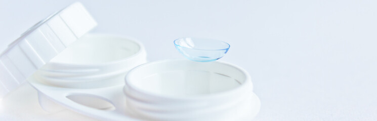 Soft contact lenses and white plastic case. Close up. Selective focus.