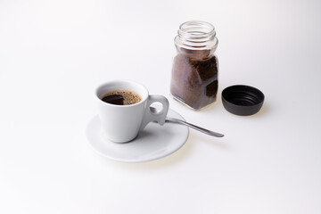 Instant granulated coffee from in a coffee cup on white background