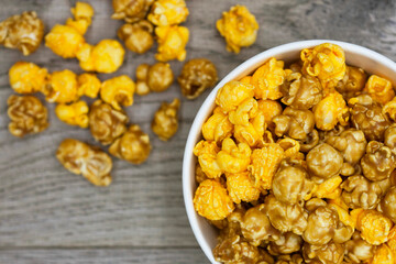 Popcorn in bucket on wooden background
