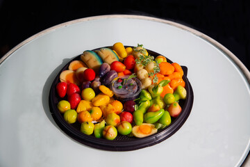 Fruit shaped like a clear glass The inside is made of nuts in jelly that imitates fruit. Is a traditional Thai dessert.on a table.
