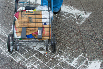Folding shopping cart in street at crosswalk
