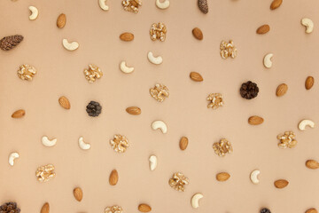 Various nuts pattern on brown background. Flat lay, top view.