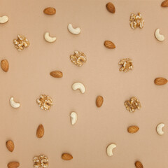 Various nuts pattern on brown background. Flat lay, top view.