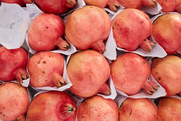 Group of pomegranates on the market. Pomegranate closeup, background