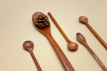 Various wooden spoons on brown background.