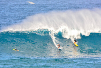 Big wave surfers at world famous Waimea Bay on the Northshore of Oahu in Hawaii. 