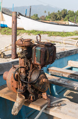 Old outboard motor with exhaust pipe rusted from sea water