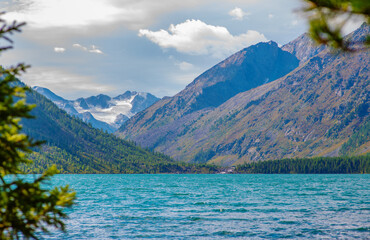 View of the multinskoe lake and snowy mountain peaks in the altai mountains