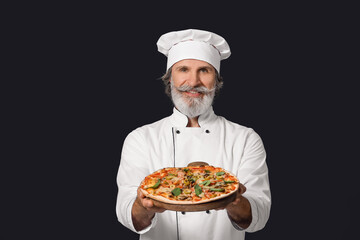 Mature male chef with tasty pizza on dark background