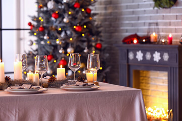 Beautiful table setting with Christmas decorations in living room