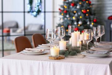 Beautiful table setting with Christmas decorations in living room
