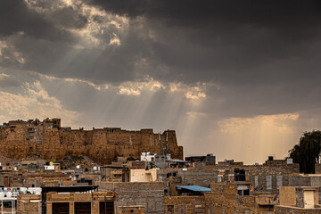 dramatic and misty cloudy and behind is jaisalmer fort