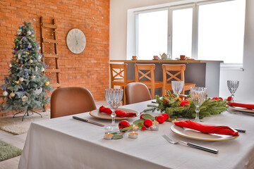 Interior of room with table set for Christmas dinner