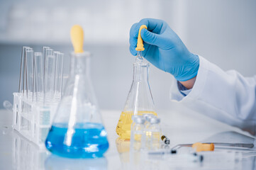 Hand of a scientist working in the laboratory. Vaccine development concept.