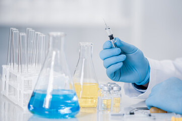 Hand of a scientist working in the laboratory. Vaccine development concept.